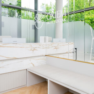 Recepcja Kliniki Dr Frąszczak – nowoczesne wnętrze z logotypem na szybie